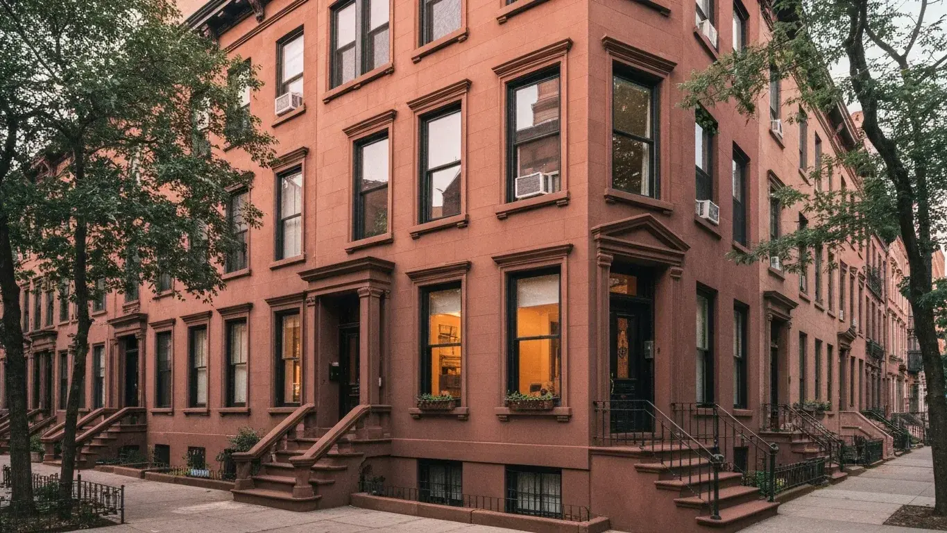 classic brownstone row house with a stoop and tall windows in New York, New York