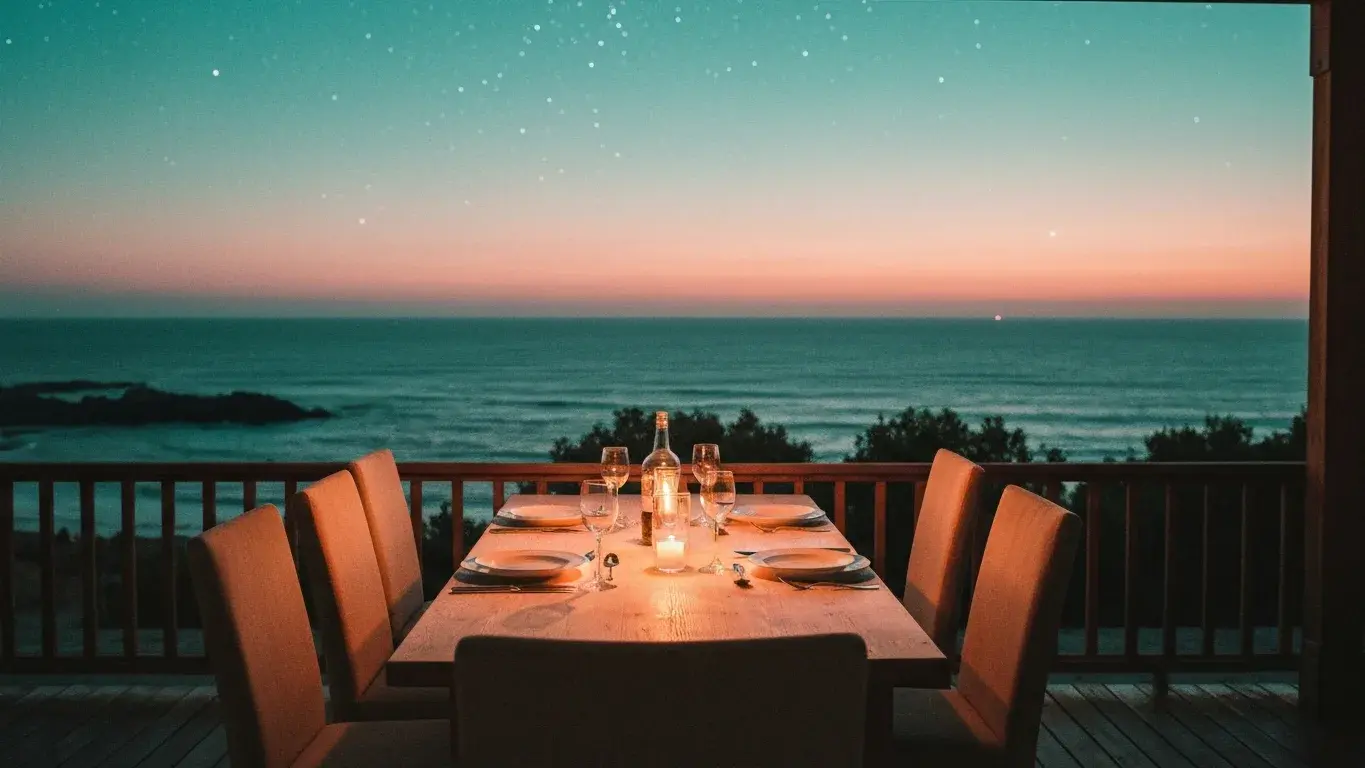 cinematic photograph of an outdoor dining table set for dinner facing the open ocean, under a starry night sky