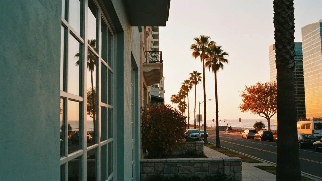 intimate exterior detail photograph of a downtown loft conversion set in a palm-lined coastal street, warm sunset, autumn foliage